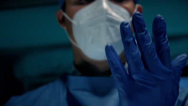 Cinematic Slow-motion of Male Surgeon Doctor Putting On Protective Medical Blue Surgical Gloves in Hospital.