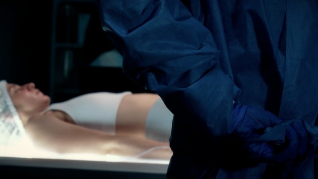 Cinematic Slow-motion of Surgeon Putting On Protective Medical Gown in Surgery Room using Hands. 