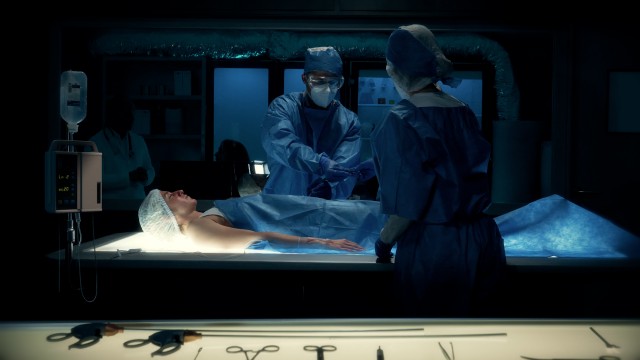 Team of Surgeons Perform a Delicate Operation Using Futuristic Surgical Bed with Light.