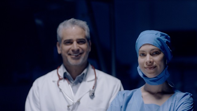 Male and Female Doctor smiling to the camera.