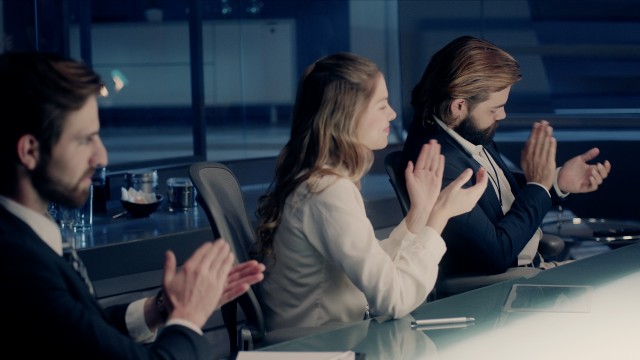 Professional Board of Executives and Clients Sitting at Corporate Meeting Room giving their applause in slow motion. Shot on ARRI ALEXA Mini UHD Cinema Camera.
