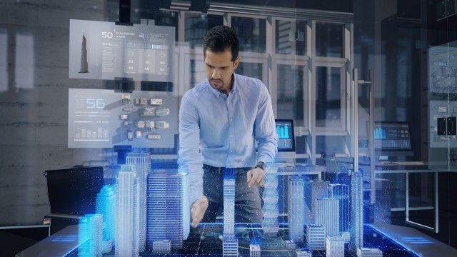 Professional Architect works with Holographic Augmented Reality 3D City Model using gestures.