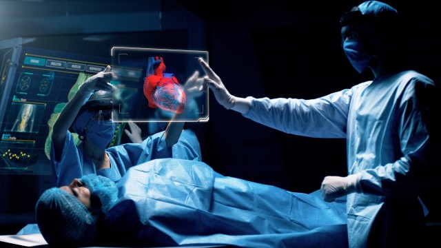 Group of surgeons using augmented reality holographic holo lens headsets interacting with a virtual interface showing patient organs. Doctor analyses HEART. Shot on RED Epic W Helium 8K Cinema Camera.