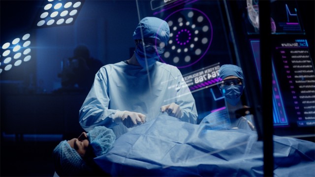Group of Surgeons using Transparent Displays Showing Patient Organs. Doctor Analyses Heart. Shot on RED Epic W Helium 8K Cinema Camera.
