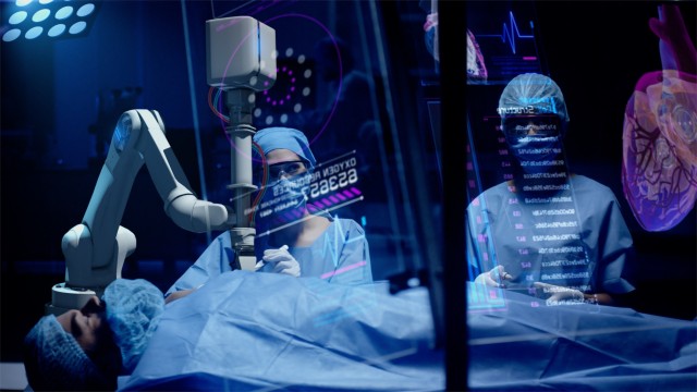 Team of surgeons perform a delicate operation using medical surgical robot while observing data on transparent screens. Modern medical equipment. Robotic arm for minimal invasive surgery.