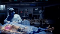 Team of Medical Surgeons use Augmented Holographic Technology to examine Patient. Doctors wear Holo Lens to view Organs, Bones and Full Anatomy of the Body of a Male Patient. Shot on RED Epic W.