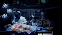 Team of Medical Surgeons use Augmented Holographic Technology to examine Patient. Doctors wear Holo Lens to view Organs, Bones and Full Anatomy of the Body of a Male Patient. Shot on RED Epic W.