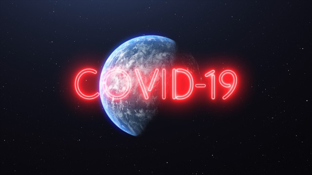 Covid-19 Red Neon Glowing Sign over the Earth. Flying away from Earth to Space showing Full Planet. Covid-19 Pandemic Asian Flu Outbreak