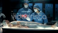 Team of surgeons perform a delicate operation using modern medical full body surgical augmented reality scanner.
