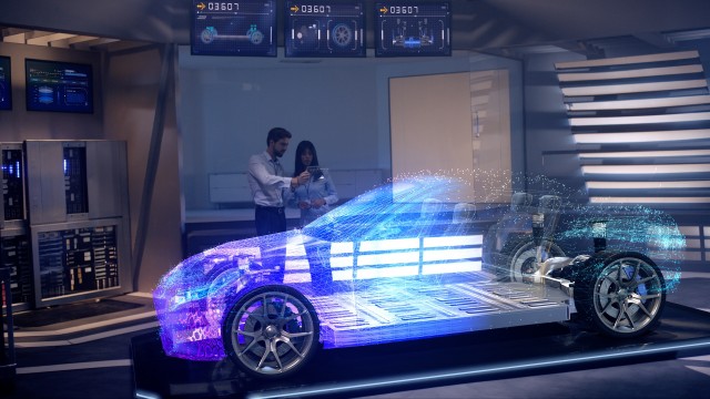 Engineers analyzing futuristic holographic car through a digital screen.