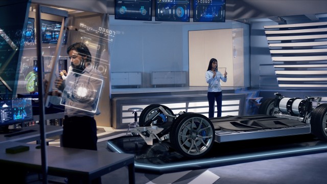 Engineers analyzing futuristic car chassis through a digital screen.