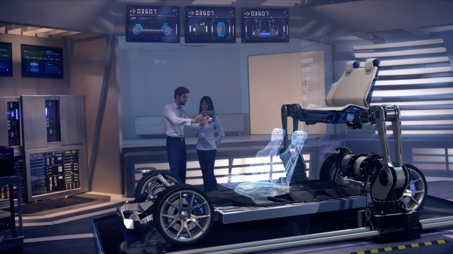Engineers analyzing futuristic reinforced chassis and futuristic robotic arms placing car seats with digital screens.