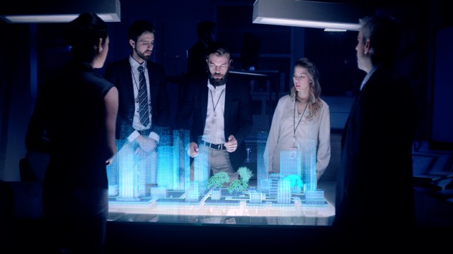 Professional Male Architect makes gestures and redesigns 3D City Model in front of boardroom. 