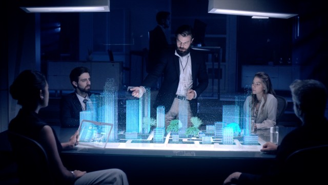 Professional Male Architect and Colleges makes gestures and redesigns 3D City Model in front of boardroom. 