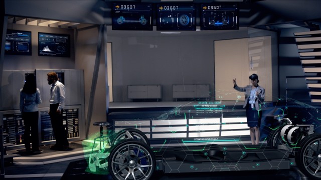 Female Engineer interacts with Hologram of Electric Car concept wearing Headset inside High-tech Industrial Facility. The Future of Augmented Reality with Graphs. 
