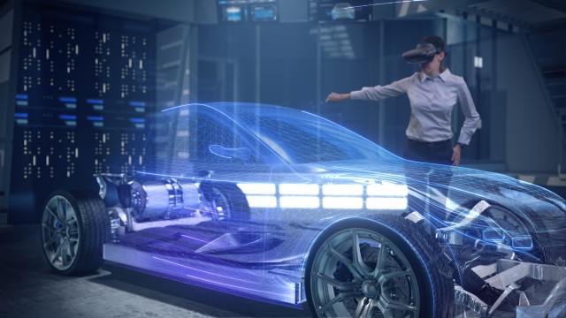 Automotive Female Professional Engineer working on design of Electric Car using Futuristic Augmented Reality Headset.