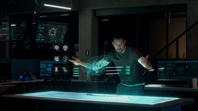 Professional AI Engineer works with Holographic Brain Interface and Infographics at Modern High Tech Research Facility. Futuristic Augmented Reality Technology. Artificial Intelligence Concept